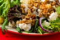 Vegetarian salad with pear, cheese, walnut and lettuce, closeup on red Royalty Free Stock Photo