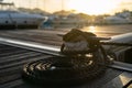 Closeup picture a rope tied to a metal cleat on a yacht deck closeup Royalty Free Stock Photo