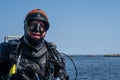 A closeup picture of a scuba diver waiting for the dive boat to get into position so he can enter the water. Ocean and