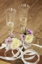 Closeup picture of shiny wedding glasses and a box of wedding rings Royalty Free Stock Photo