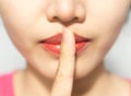 Closeup picture of woman making a hush gesture