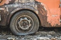 Closeup pictures of an orange old car that has been left to decay, tires become flat and rust