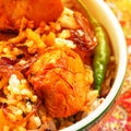 Closeup piece of chicken tikka and saffron strands Indian Biryani served