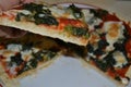 Closeup of Piece of Homemade White Spinach Pizza with Mozzarella Cheese.