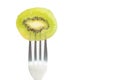 Closeup of a piece of kiwi on fork with copy space on white Royalty Free Stock Photo