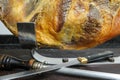 Closeup of a piece of pork meat's thigh part in a steel holder Royalty Free Stock Photo