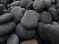 Closeup of a pile of beautiful dark grey big and small stones