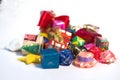 Closeup pile of gift boxes wrapped by colourful paper for Christmas festival with isolated background.