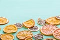 Closeup of a pile of handmade citrus chips: orange, lemon, grapefruit on turquoise wooden background