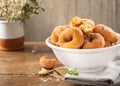 Closeup of a pile of homemade rosquillas, traditional homemade anise donuts from Spain, typically eaten in Easter, on a rustic