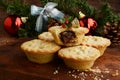 Closeup pile of mincemeat pies with christmas ornaments