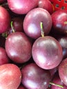 Closeup of a pile of purple passion fruits