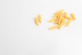 Closeup of a pile of raw penne isolated on a white background Royalty Free Stock Photo