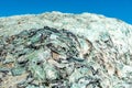 Pile of recycle pieces of broken glass under blue sky