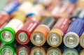 Closeup of pile of used alkaline batteries. Closeup colorful rows of AA storage batteries Royalty Free Stock Photo