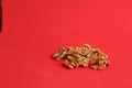 Closeup of a pile of walnut kernels on a red surface