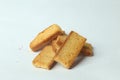 Closeup of piled rectangular pieces of bread on a white surface