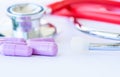 Closeup pills, capsule and stethoscope on white background