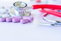 Closeup pills, capsule and stethoscope on white background.