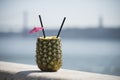 pinacolada cocktail on a pineapple on river background