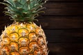 Closeup of a pineapple on dark wooden background Royalty Free Stock Photo