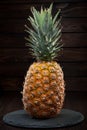 Closeup of a pineapple on dark wooden background Royalty Free Stock Photo