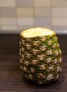 Closeup of a pineapple with a top cut off, a tasty ingredient for juice or smoothie Royalty Free Stock Photo