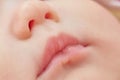 Closeup of pink baby lips and nose. Soft skin