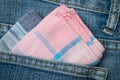 Pink fabric hanky in blue jeans pocket