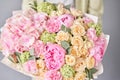 Closeup Pink peonies and hydrangea. Beautiful bouquet of mixed flowers in woman hand. Floral shop concept . Handsome