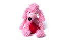 pink poodle toy with red heart sitting on white backg