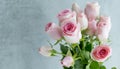 Closeup of pink roses with green small leaves that are a part of a bouquet