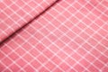 Closeup of pink tablecloth background. Detail of fabric in picnic pattern