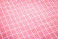 Closeup of pink tablecloth background. Detail of fabric in picnic pattern