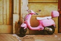 Closeup of a pink vintage scooter Royalty Free Stock Photo