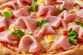 Closeup of pizza with ham, quail eggs, tomatoes and greens on melted mozzarella Royalty Free Stock Photo