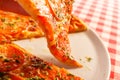 Close up eating piece of pizza Margarita. Delicious hot food sliced and served on white platter. Menu photo, Italian Royalty Free Stock Photo