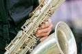A closeup plane of saxophone in hands of sax player