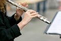 A closeup plane of street orchestra flute player