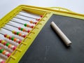 Plastic Colorful Beeds for Abacus , Black Board Slate with Chalk Piece on white background