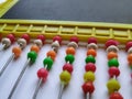 Plastic Colorful Beeds for Abacus , Black Board Slate with Chalk Piece on white background