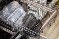 closeup of plastic containers in a dishwasher, in a kitchen