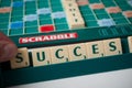 Closeup of plastic letters with word success on Scrabble board game Royalty Free Stock Photo