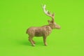 Closeup of a plastic reindeer toy on a green background