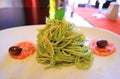 Closeup a plate of delectable spaghetti in pesto sauce