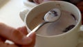 Closeup plate flakes with milk mom feed young baby in white feeding up high chair, kid is trying to eat himself, child Royalty Free Stock Photo