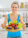 Closeup on plate of fruits giving by smiling woman Royalty Free Stock Photo