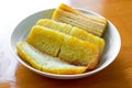 Closeup of a plate of golden Indonesian cakes, Southeast Asian cuisine