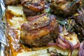 Closeup of a plate of grilled lamb chops with onions and potatoes Royalty Free Stock Photo