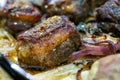 Closeup of a plate of grilled lamb chops with onions and potatoes Royalty Free Stock Photo